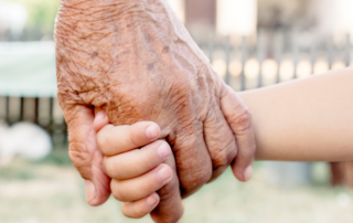 Grandparent and grandchild holding hands